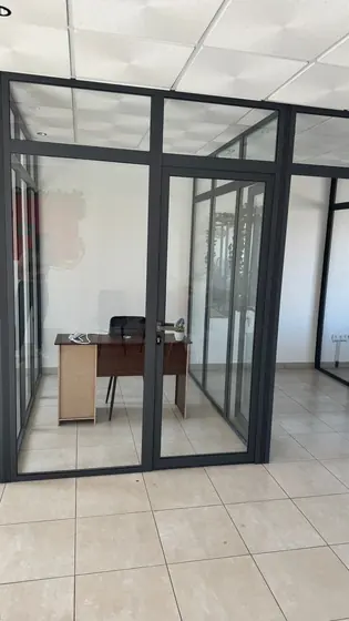 Bureau individuel isolé par une cloison vitrée en aluminium noir